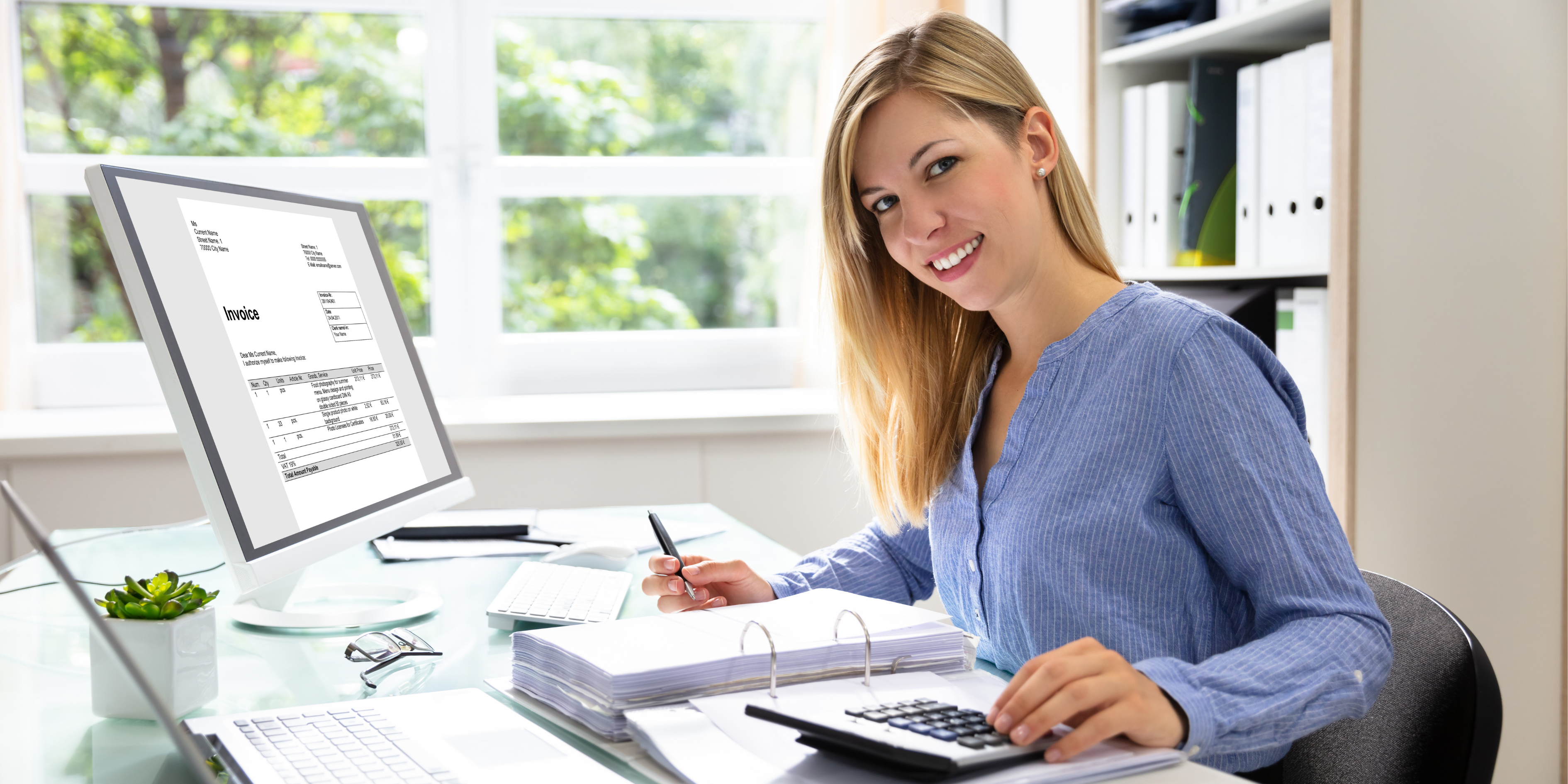 Woman in home workspace doing bookkeeping