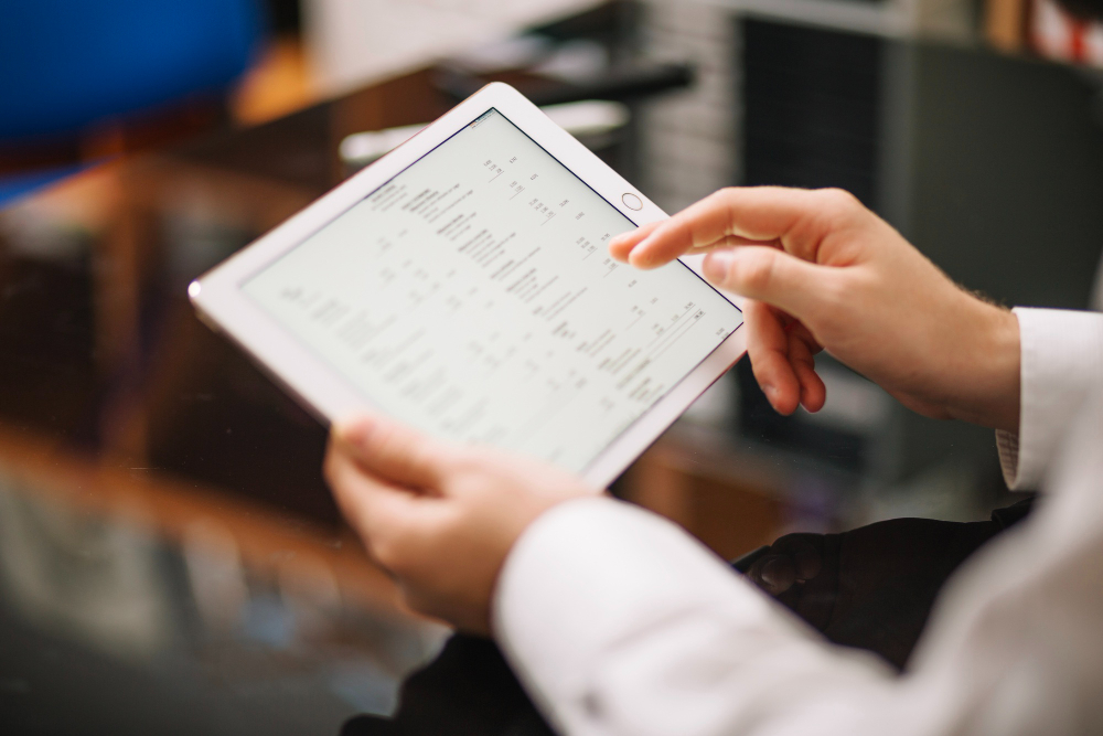 Bookkeeping professional monitoring business expenses on digital report