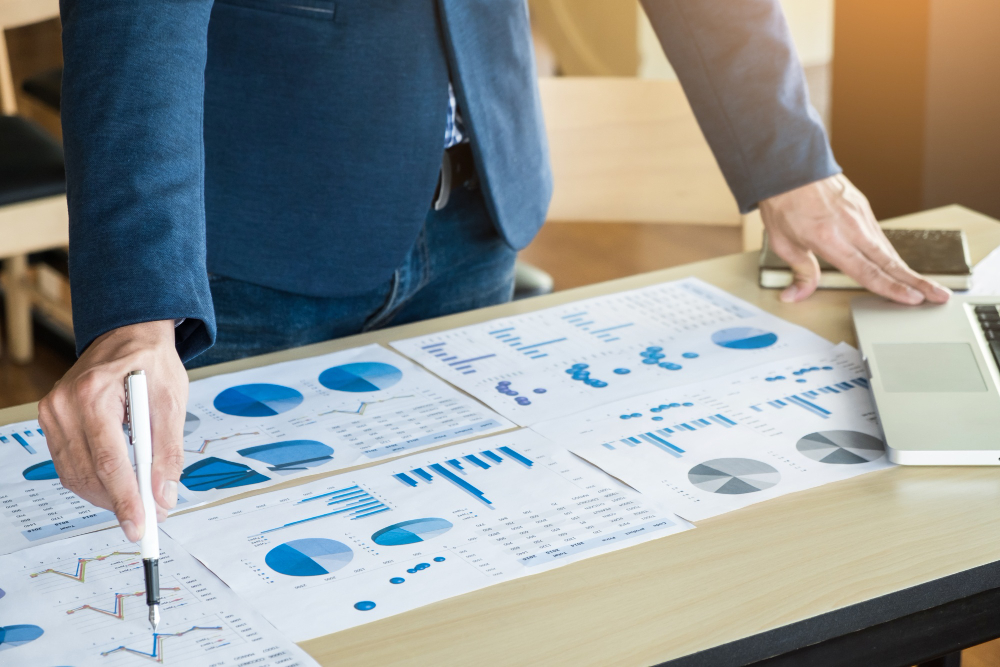 Person reviewing financial charts and preparing Business Activity Statement reports